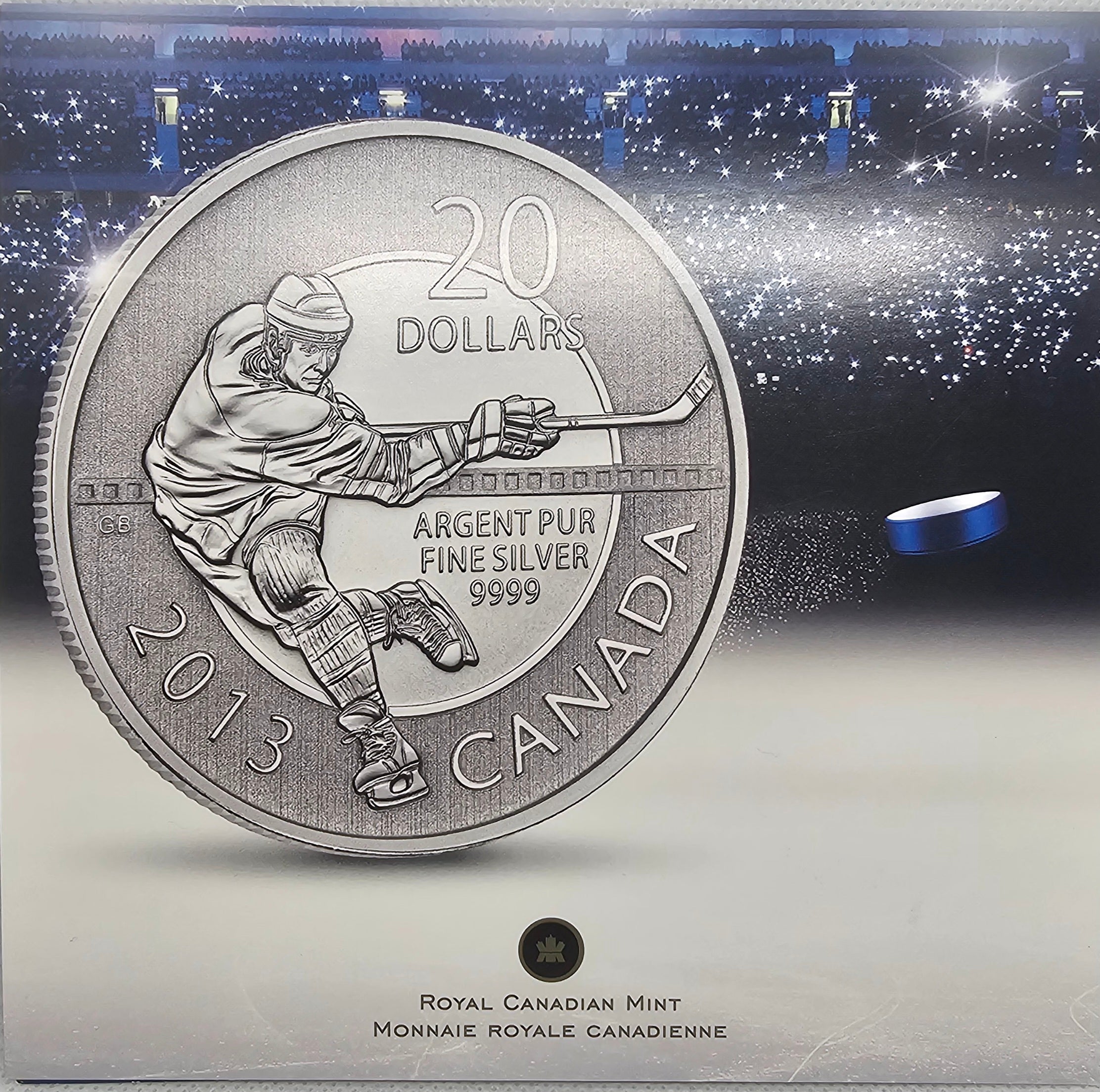 2013 Canada $20 Hockey silver coin in original packaging with arena background.