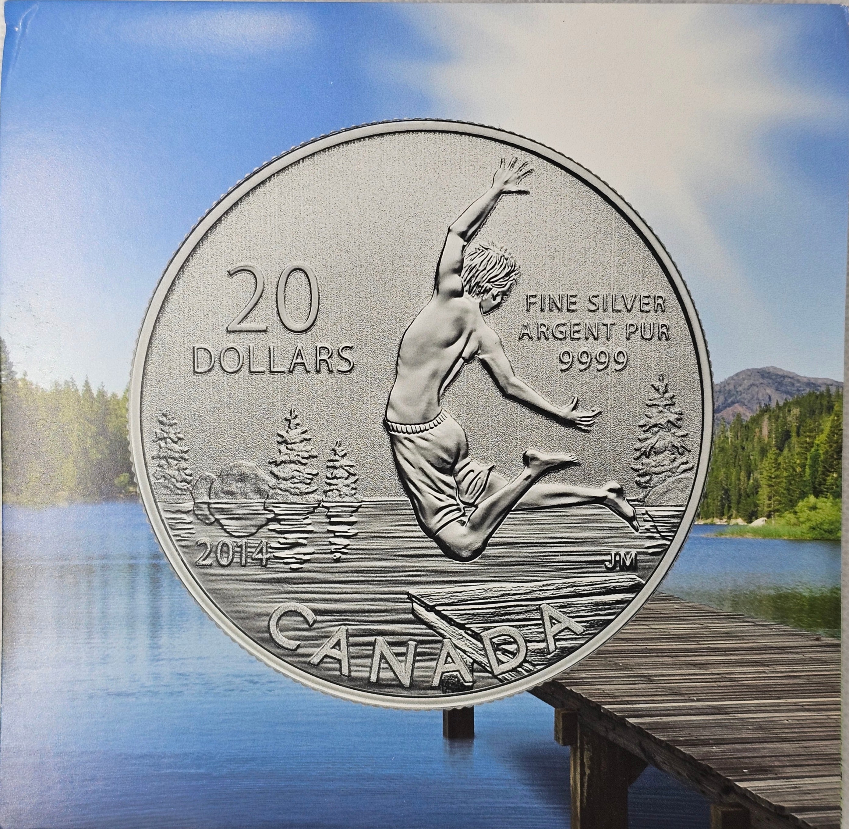 2014 Canada $20 Summer Fun silver coin in original packaging with lake and dock background.