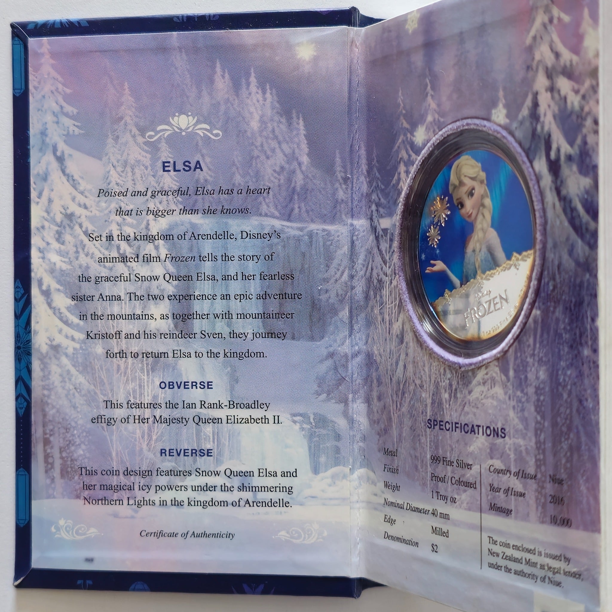 “Colourised Elsa Frozen 1 oz 999 silver coin in a themed display book, showing specifications and certificate of authenticity.”