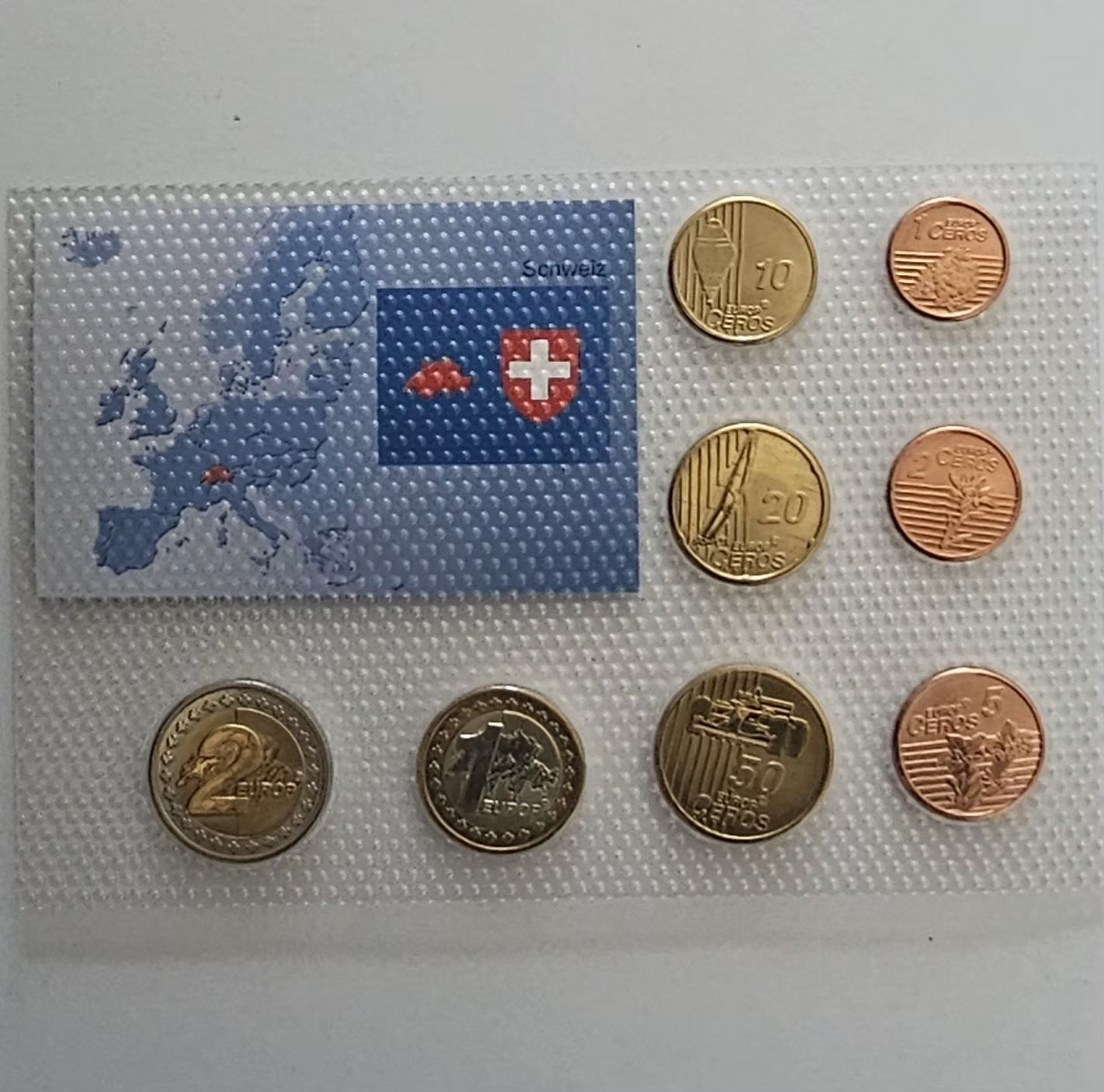 Switzerland euro pattern coins, value sides, card with map of Switzerland